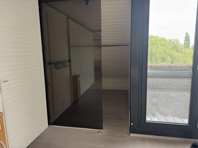 Bright modern penthouse bedroom for student rental, with shared common space, near Howest Kortrijk